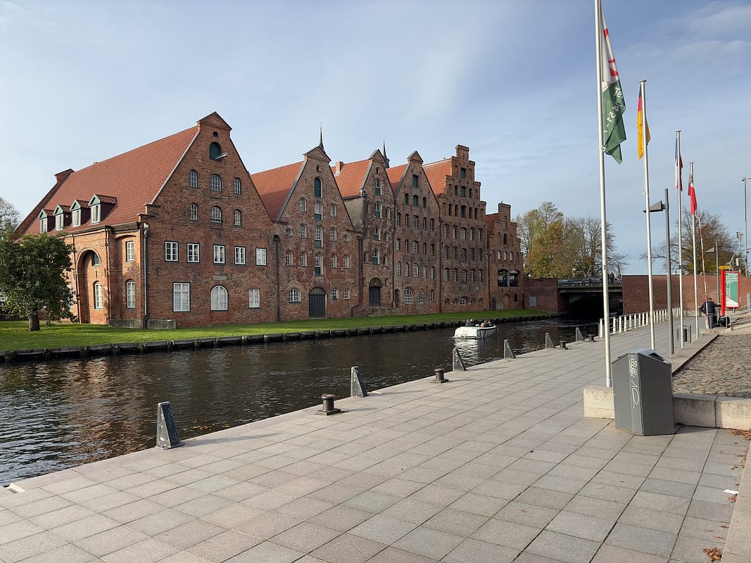 a large brick building with flags in front of it